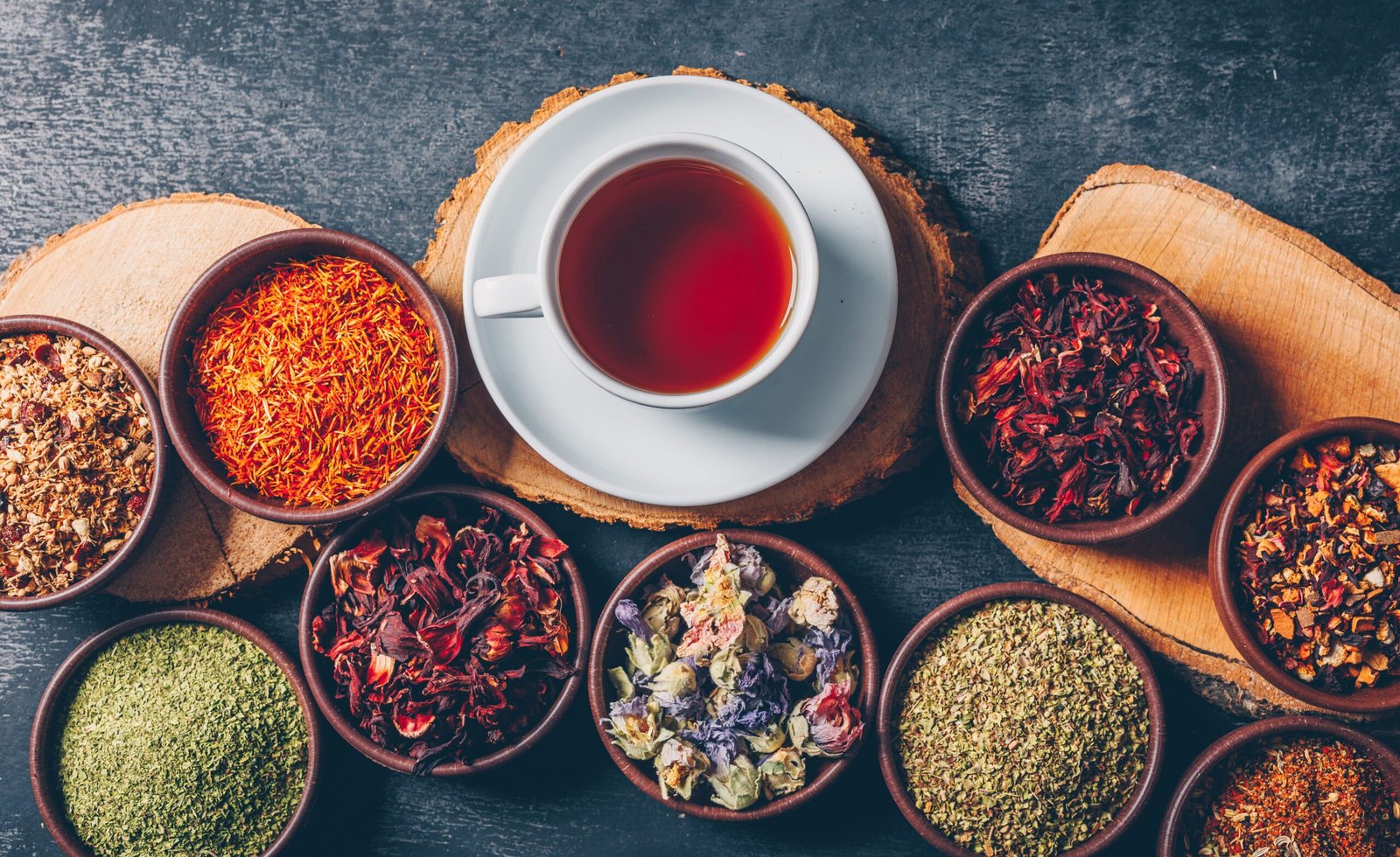 set-wood-stubs-cup-tea-tea-herbs-bowls-dark-textured-background-flat-lay (1)